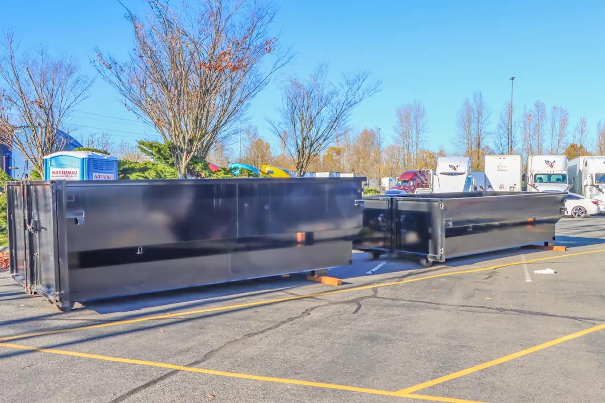 Professional dumpster rental service with roll-off container on residential driveway in Wilkes-Barre